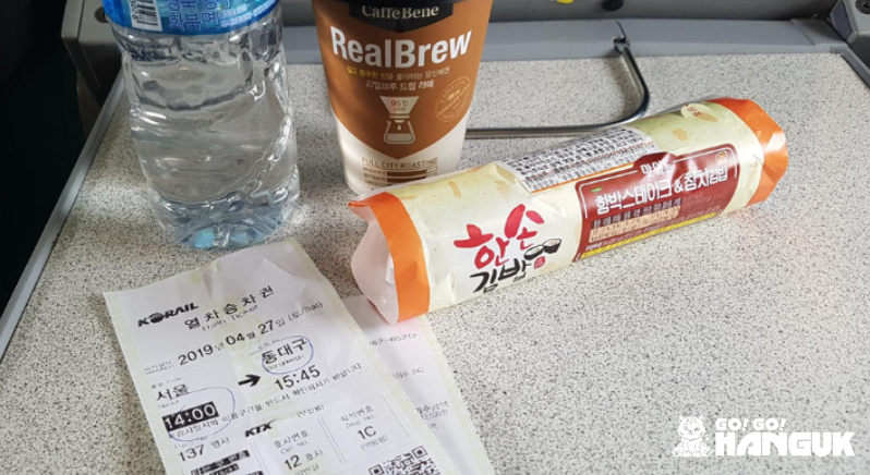 Snacks and Korail train receipts on a tray