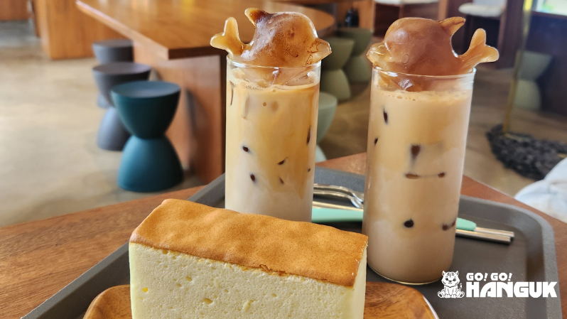 Latte drinks and cake on a table