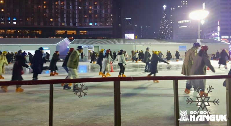 People ice skating at night